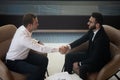 Top view of smiling multiethnic businessmen handshake greeting at meeting Royalty Free Stock Photo