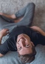 Smiling young man sitting on the floor and looking at the camera. Royalty Free Stock Photo