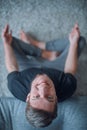 Smiling young man sitting on the floor and looking at the camera. Royalty Free Stock Photo