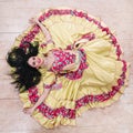 Top view. smiling young woman performing passionate Gypsy dance.