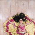 Top view. smiling young woman performing passionate Gypsy dance.