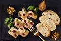 Top view of smoked herring fillets with cranberries and bread on black slate board