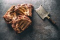 Top view of smoked ribs on a dark metallic surface next to a vintage knife Royalty Free Stock Photo