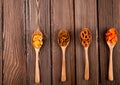 top view snacks mini brezel fish crackers paprika chips and hard chuck on spoons with copy space on wooden background