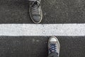 Top view of sneakers from above, standing next to white street l Royalty Free Stock Photo