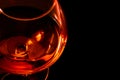 Top of view of snifter of brandy in elegant typical cognac glass on black background