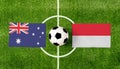 Top view soccer ball with Australia vs. Monaco flags match on green football field