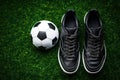 Top view of soccer ball and pair of football sports shoes on soccer field. Generative AI Royalty Free Stock Photo