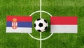 Top view soccer ball with Serbia vs. Monaco flags match on green football field