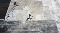 Top view, soccer player and man in fitness, training and workout practice on city building rooftop in Portugal. Sports