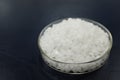 Top view of sodium or potassium hydroxide white chemical compound pellets or prills in a petri dish. Royalty Free Stock Photo