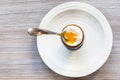 Soft-boiled brown egg with spoon on plate on gray Royalty Free Stock Photo