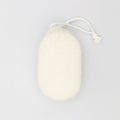 Top view of soft cleaning cotton oval sponge for body skincare shower scrubbing on white background