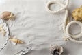 Top view of soft sand and seashell, starfish, marine ropes on it.Empty space for text