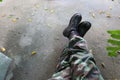 top view of soldier legs in training uniform Wear black leather combat shoes. sitting on the road selectable focus