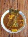 Top view, sour curry with fish and young coconuts, delicious southern food, healthy to put on a wooden table, Thai food concept
