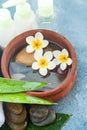 Top view of spa objects and stones, flowers and bottles