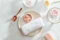 Top view of Spa products with towel and oil on plate, flowers, soap on white background Royalty Free Stock Photo