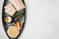 Top view of spa products in a tray with essential oil bottle, rosemary herb, towel, natural soaps, candle and body brush, spa and Royalty Free Stock Photo