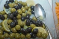 Top view with space for text . Green and black olives in a white ceramic bowl Royalty Free Stock Photo