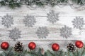 Top view. Space for your text. Old wooden Christmas background. Garlands, baubles and snowflakes. Fir branches and cones Royalty Free Stock Photo