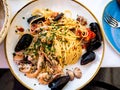 Top view of spaghetti allo scoglio or spaghetti with seafood served in a white dish with shrimps