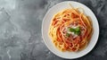 Top view of Spaghetti Bolognese in a white plate on black slate background with copy space. Italian pasta with minced Royalty Free Stock Photo