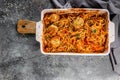 Top view spaghetti with meatballs with tomato sauce and herbs in a baking dish. Italian traditional pasta. Mediterranean Kitchen.