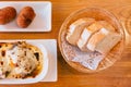 Top view of Spanish fresh baked bread in basket with Lasagne and Papas Rellenas. Served as appetizer Royalty Free Stock Photo