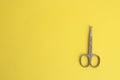 Top view of special nail scissors for babies on a yellow background