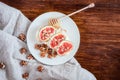 Top view spelt sourdough toast with feta cheese spread, fresh figs with honey, and raw walnut. Vintage wooden table