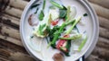 Top of view of spicy coconut Thai soup on a wooden table. 1920x1080