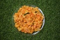 Top view of spicy corn flakes placed on green grass Royalty Free Stock Photo