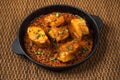 Top view of spicy and hot Bengali fish curry. Indian food. Fish curry with red chili, curry leaf, coconut milk. Asian cuisine.