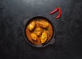 Top view of spicy and hot Bengali fish curry. Indian food. Fish curry with red chili, curry leaf, coconut milk. Asian cuisine. Royalty Free Stock Photo