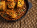 Top view of spicy and hot Bengali fish curry. Indian food. Fish curry with red chili, curry leaf, coconut milk. Asian cuisine. Royalty Free Stock Photo