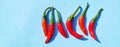 Top view of spicy red chili peppers on blue background with copy space