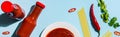 Top view of spicy tomato sauce beside raw spaghetti and chili pepper on blue background, panoramic shot Royalty Free Stock Photo