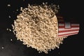 top view of spilled popcorn with striped red bucket Royalty Free Stock Photo