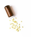 Top view of the spilled yellow pills from the medicine glass bottle. Royalty Free Stock Photo