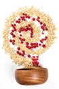 Top view, spiral with oatmeal and red currant berries with wooden bowl