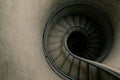 A top view of the spiral staircase leading into the darkness. Space for text. Royalty Free Stock Photo