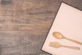 Top view spoon, fork and book on wooden plank background