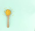 Top view spoon of hulled split mung beans on light blue background