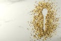 Top view of spoon silhouette and raw healthy cereals on the white marble table.Empy space