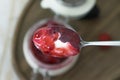 Top view of a spoon of yogurt with jam with a blurry background