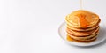 Top view of a stack of fluffy pancakes on white plate, drizzled with maple syrup and topped with fresh berries Royalty Free Stock Photo