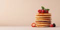 Top view of a stack of fluffy pancakes on white plate, drizzled with maple syrup and topped with fresh berries Royalty Free Stock Photo