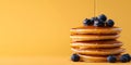 Top view of a stack of fluffy pancakes on white plate, drizzled with maple syrup and topped with fresh berries Royalty Free Stock Photo