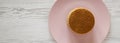 Top view, stack of homemade Dutch stroopwafels with honey-caramel filling on a pink plate, overhead view. Flat lay, from above,